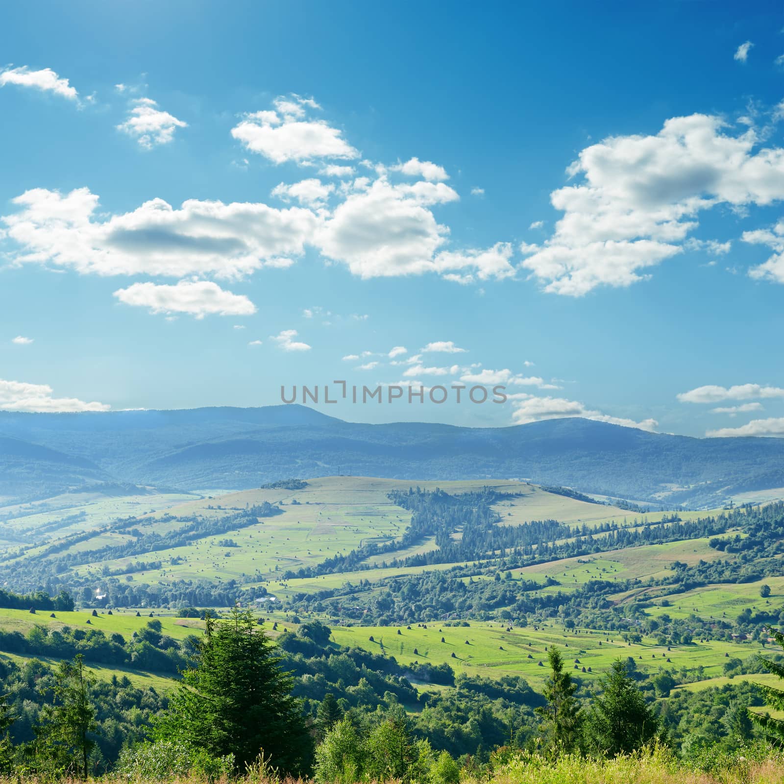 clouds over green mountain