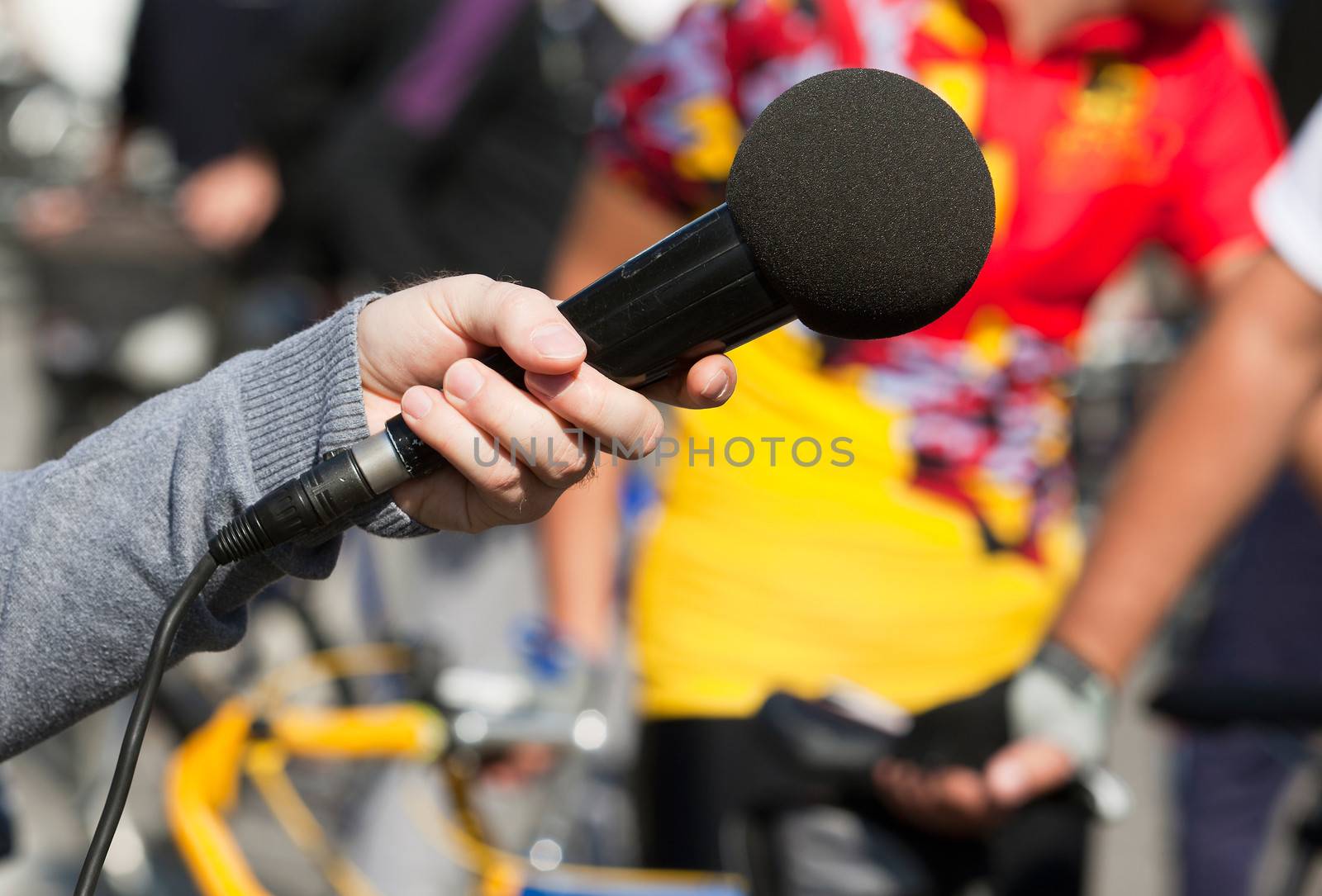 A journalist is making a interview with a microphone