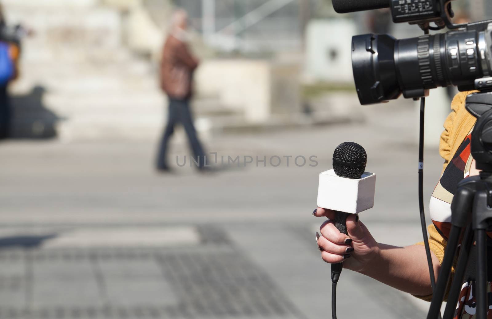 A journalist is making a interview with a microphone