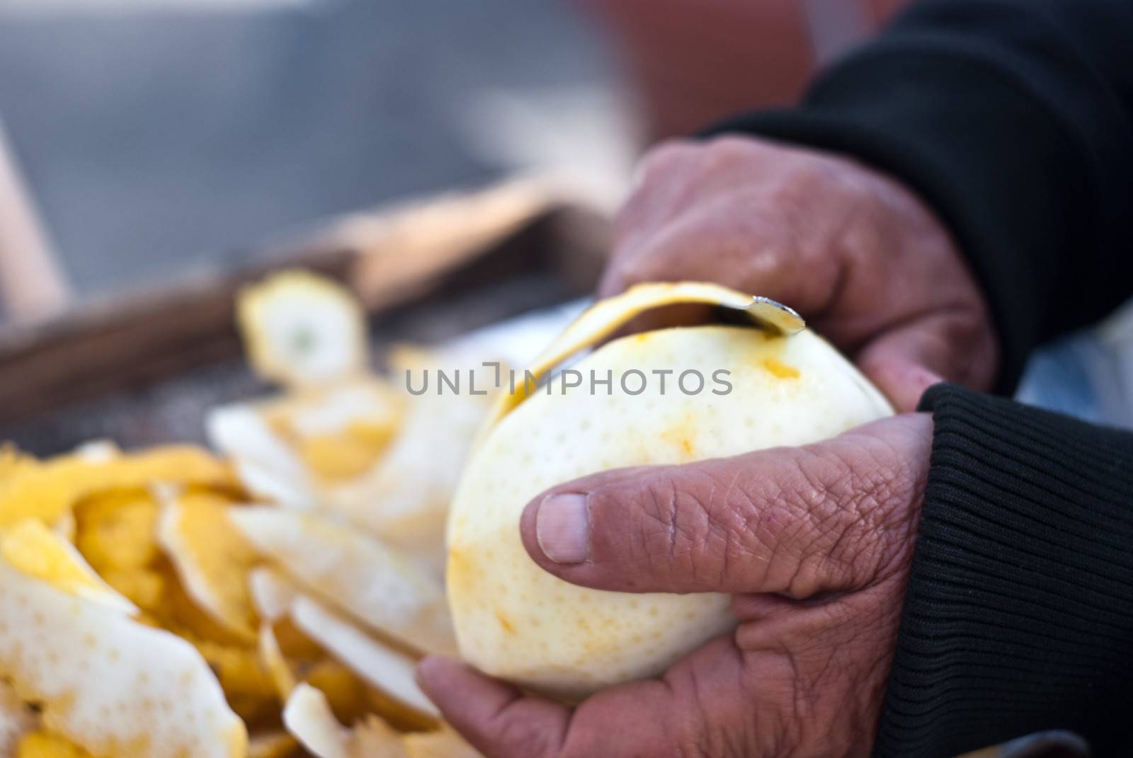 hands of an old Sicilian man cutting a citron