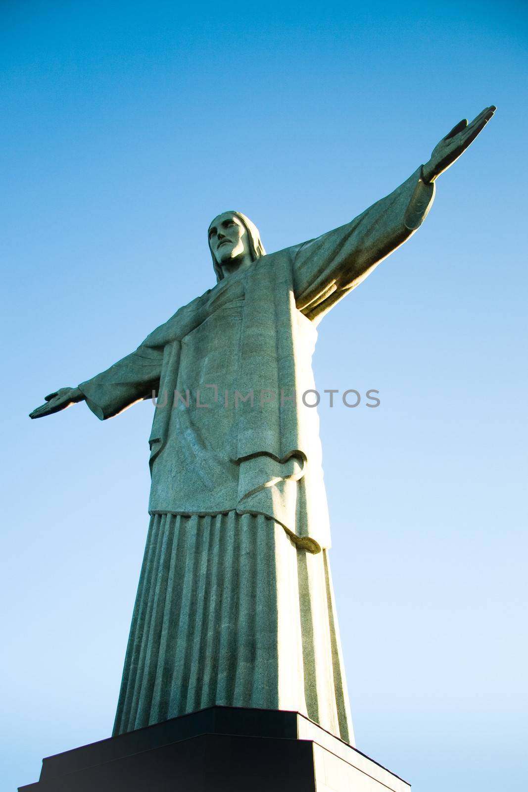 Low angle view of Christ the Redeemer statue with blue sky background, Rio de Janeiro, Brazil.