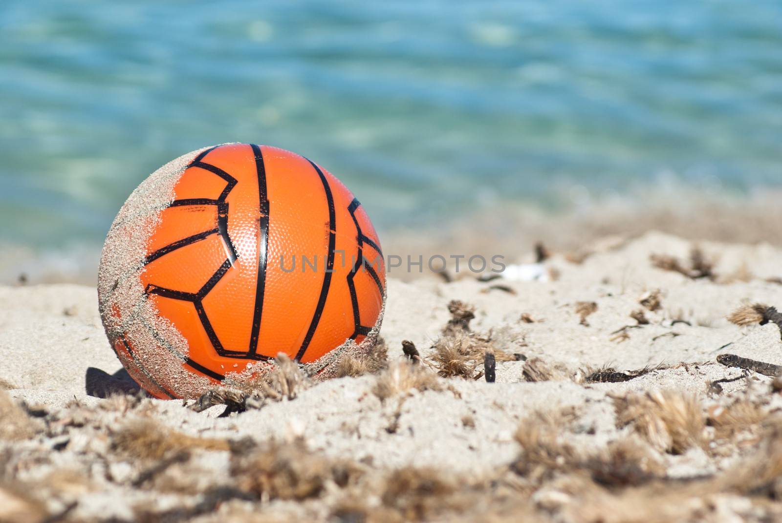 Red ball in the sand.