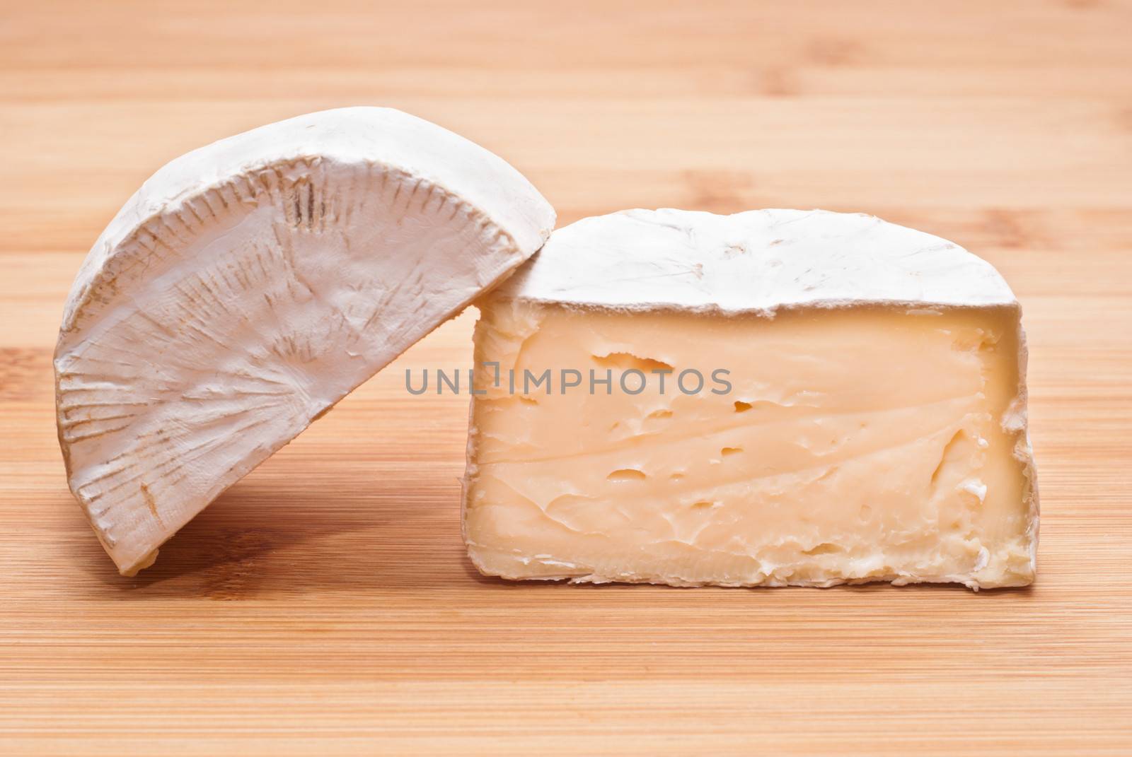 Soft cheese isolated on a wooden board