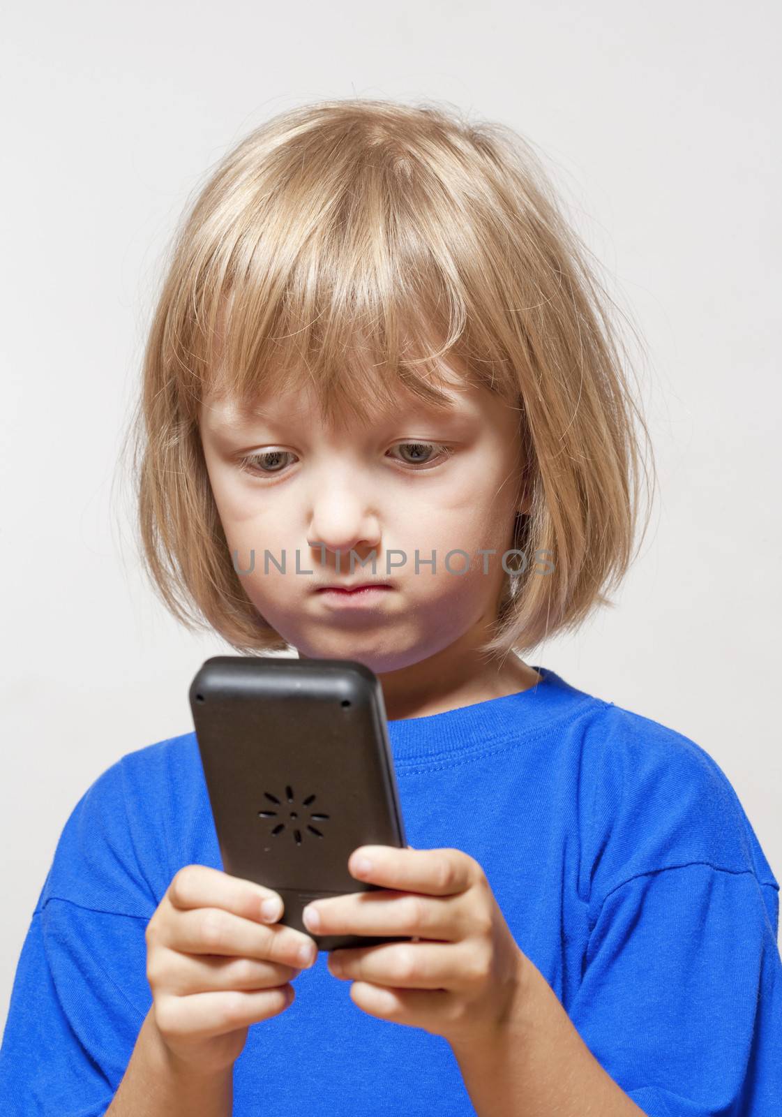 boy playing with handheld computer game - isolated on light gray