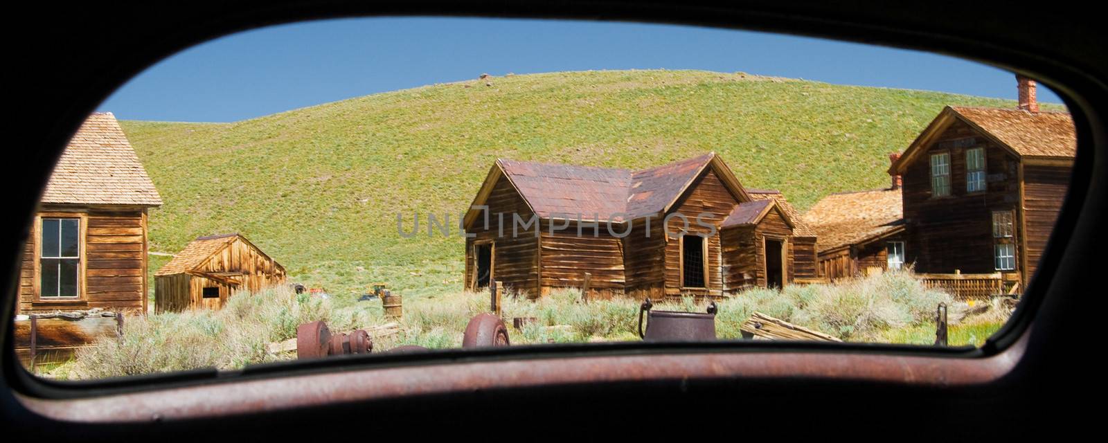 Abandoned buildings viewed through from a mirror of a car, Bodie Ghost Town, Bodie State Historic Park, Mono County, California, USA