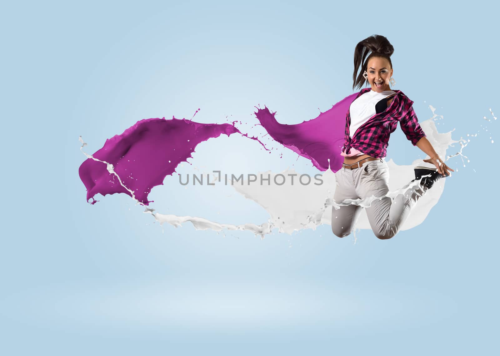 young female dancer jumping with splash of paint by adam121