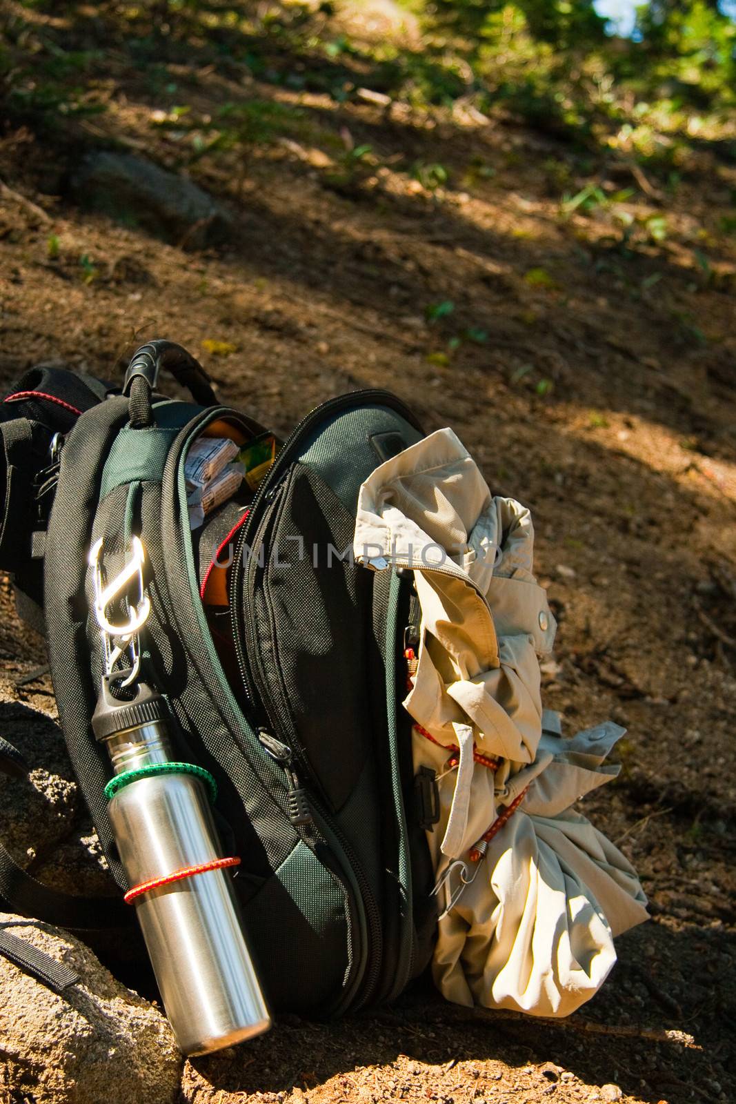 Open hikers rucksack showing equipment on hillside trail to Taft Point in Yosemite Park, California, U.S.A.