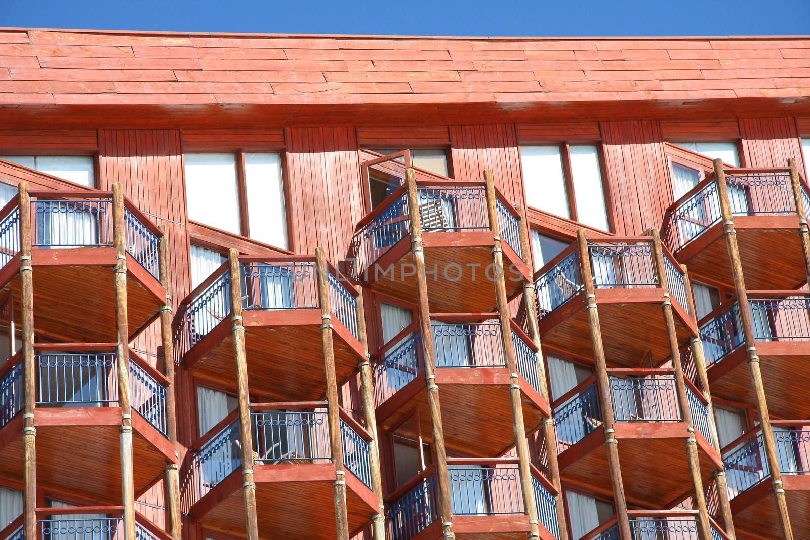 Wooden hotel with view of patios.