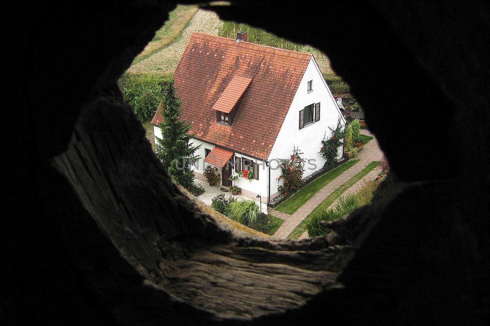 House viewed through hole in wall by CelsoDiniz