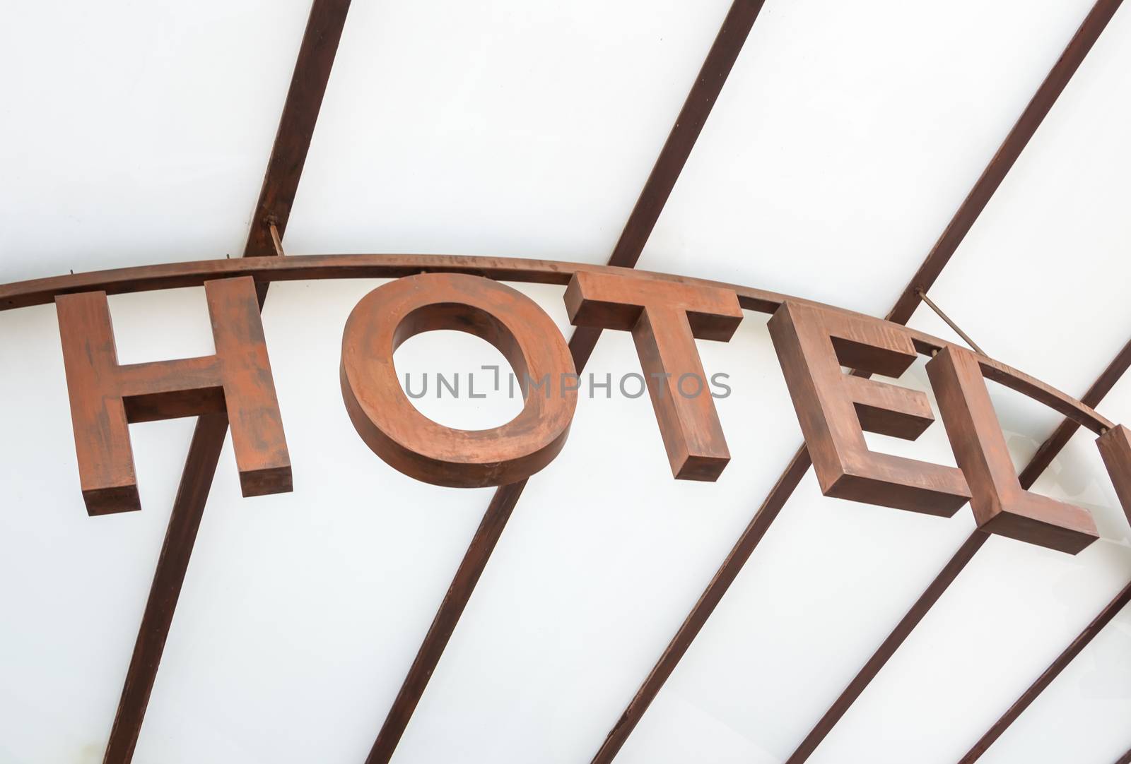 Modern hotel sign over a glass canopy entrance