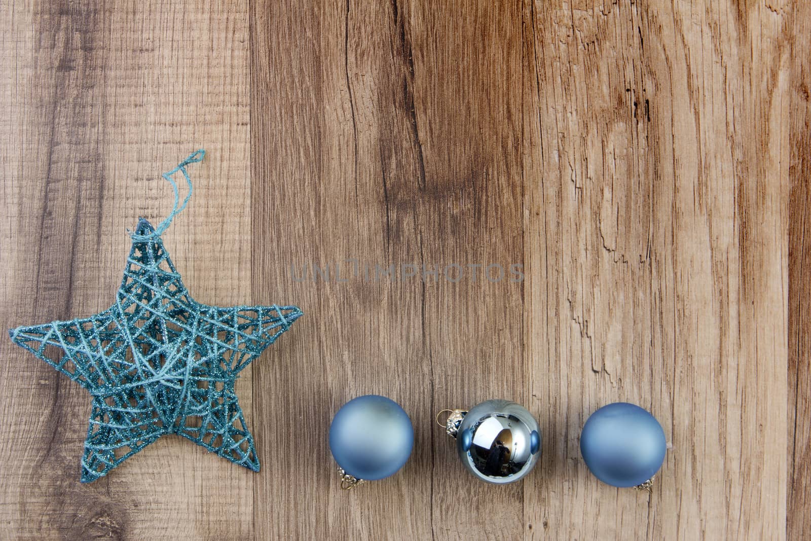 christmas baubles blue and moravian star with wooden background 