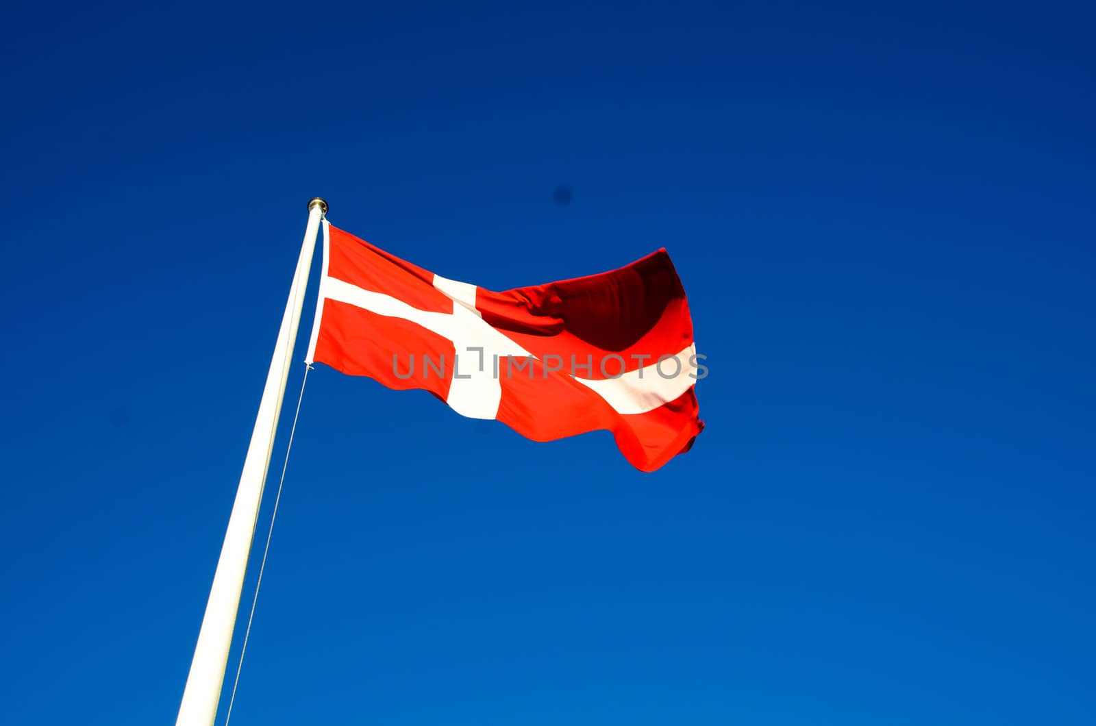 Danish flag waves in the breeze on a summer day