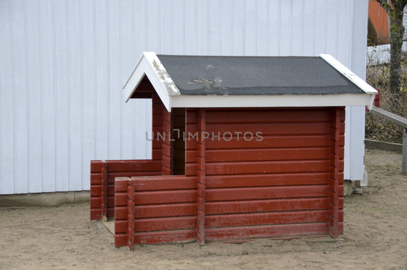 A red small fine Playhouse on playground