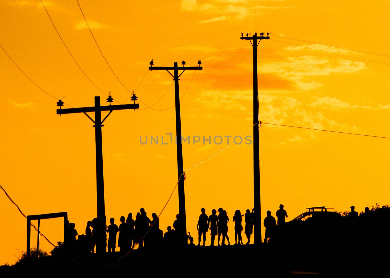 The silhouette of a bunch of people waiting for the sunset at the Pontal do Atalaia in Arraial do Cabo, Rio de Janeiro, Brazil.