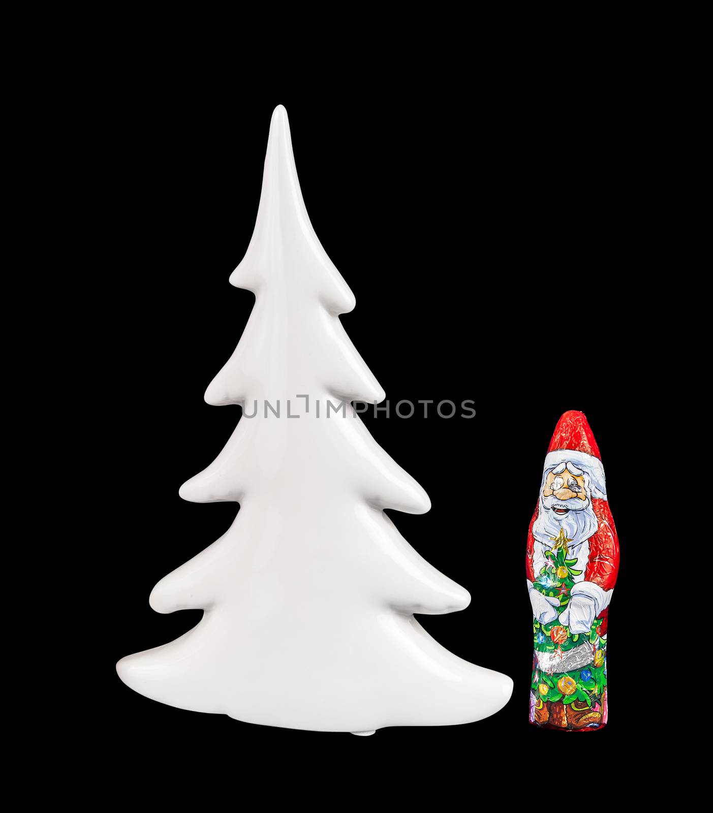 Chocolate figure of santa Claus and Christmas tree isolated over black background with clipping path.