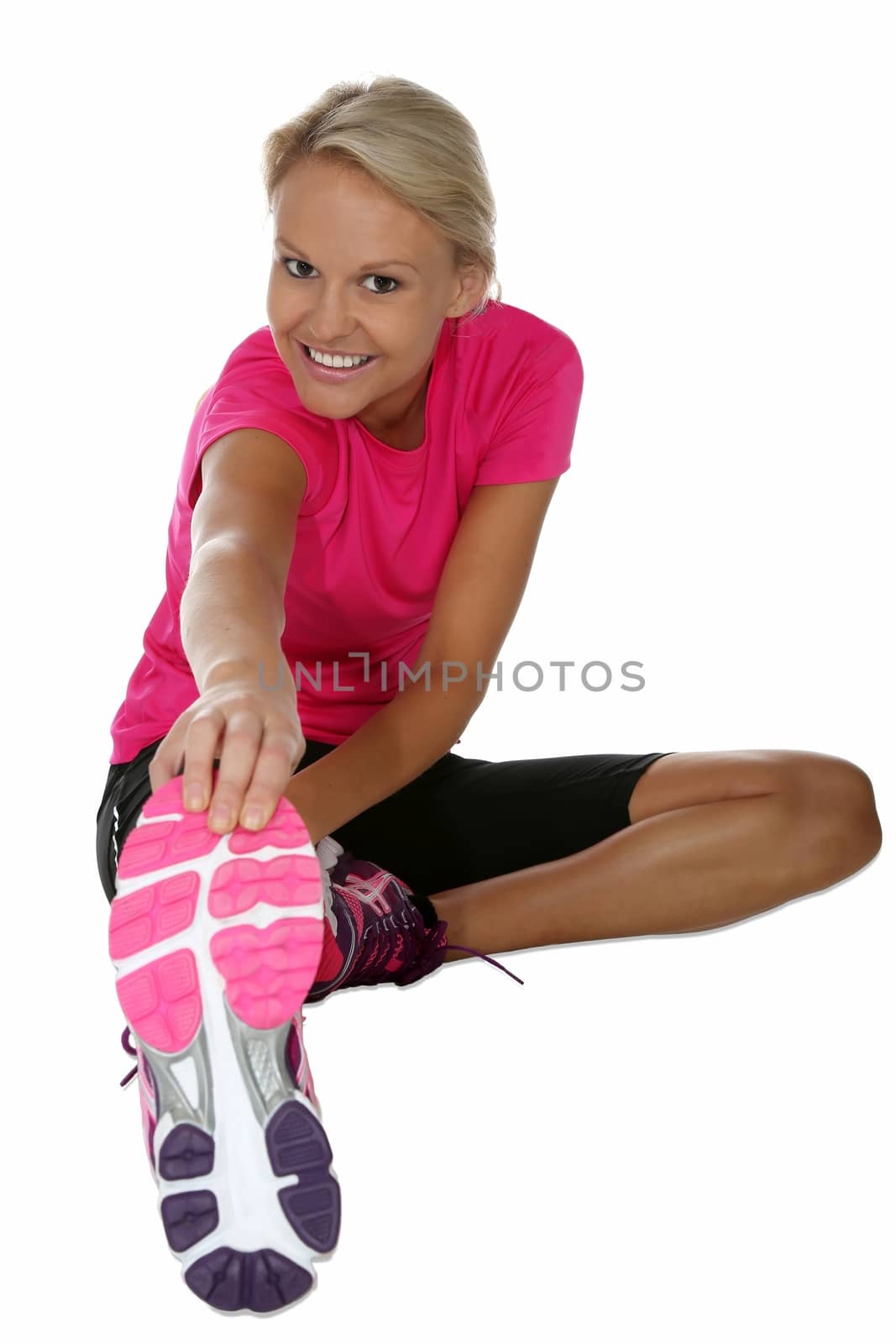 Beutiful young blond lady athlete doing warm up streches