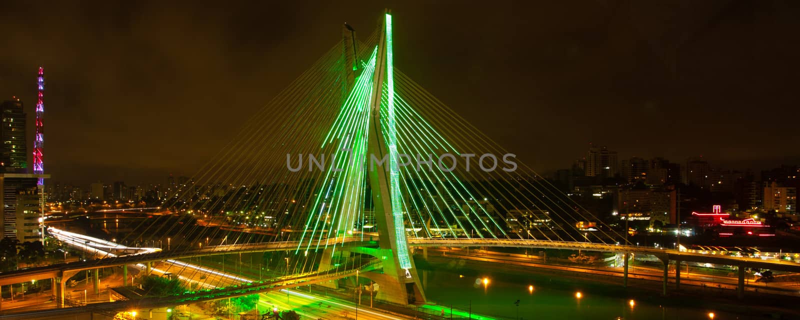 Octavio Frias de Oliveira bridge illuminated at night over Pinheiros river in Sao Paulo, Brazil.