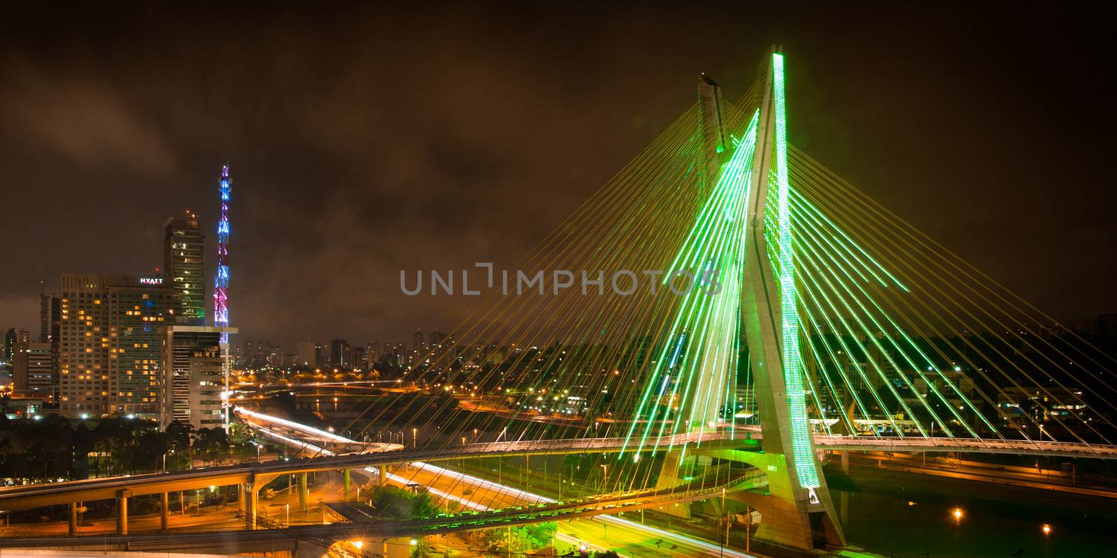 Scenic view of Octavio Frias de Oliveira bridge illuminated at night over Pinheiros river in Sao Paulo, Brazil.