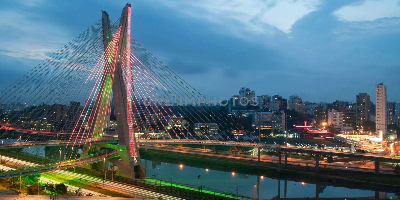 Scenic view of Octavio Frias de Oliveira bridge illuminated at night over Pinheiros river in Sao Paulo, Brazil.