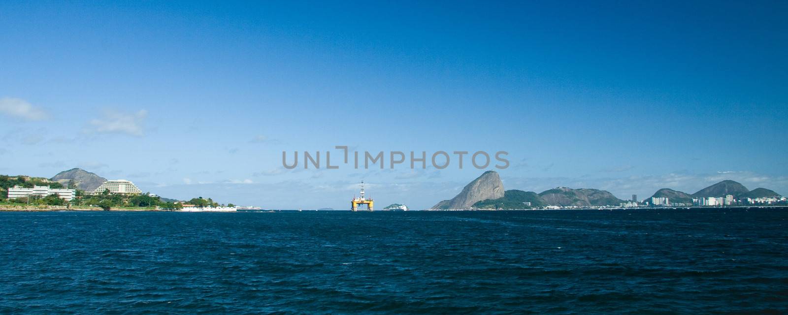Distant view of Sugarloaf Mountain and Oil Rig in Rio De Janeiro, Brazil