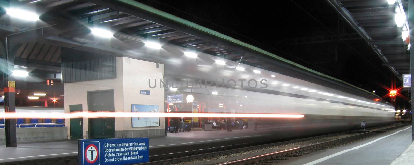 The lights of a fast train passing by at the Geneva Station.