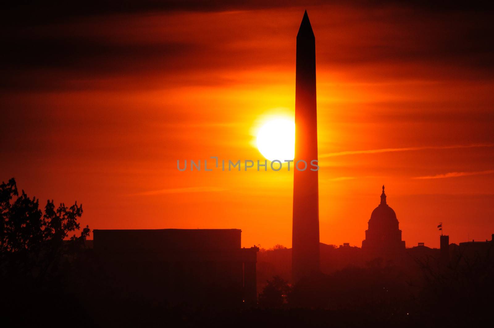 Lincoln Memorial and Washington Monument silhouetted with red sunset background, Washington, D.C, U.S.A.