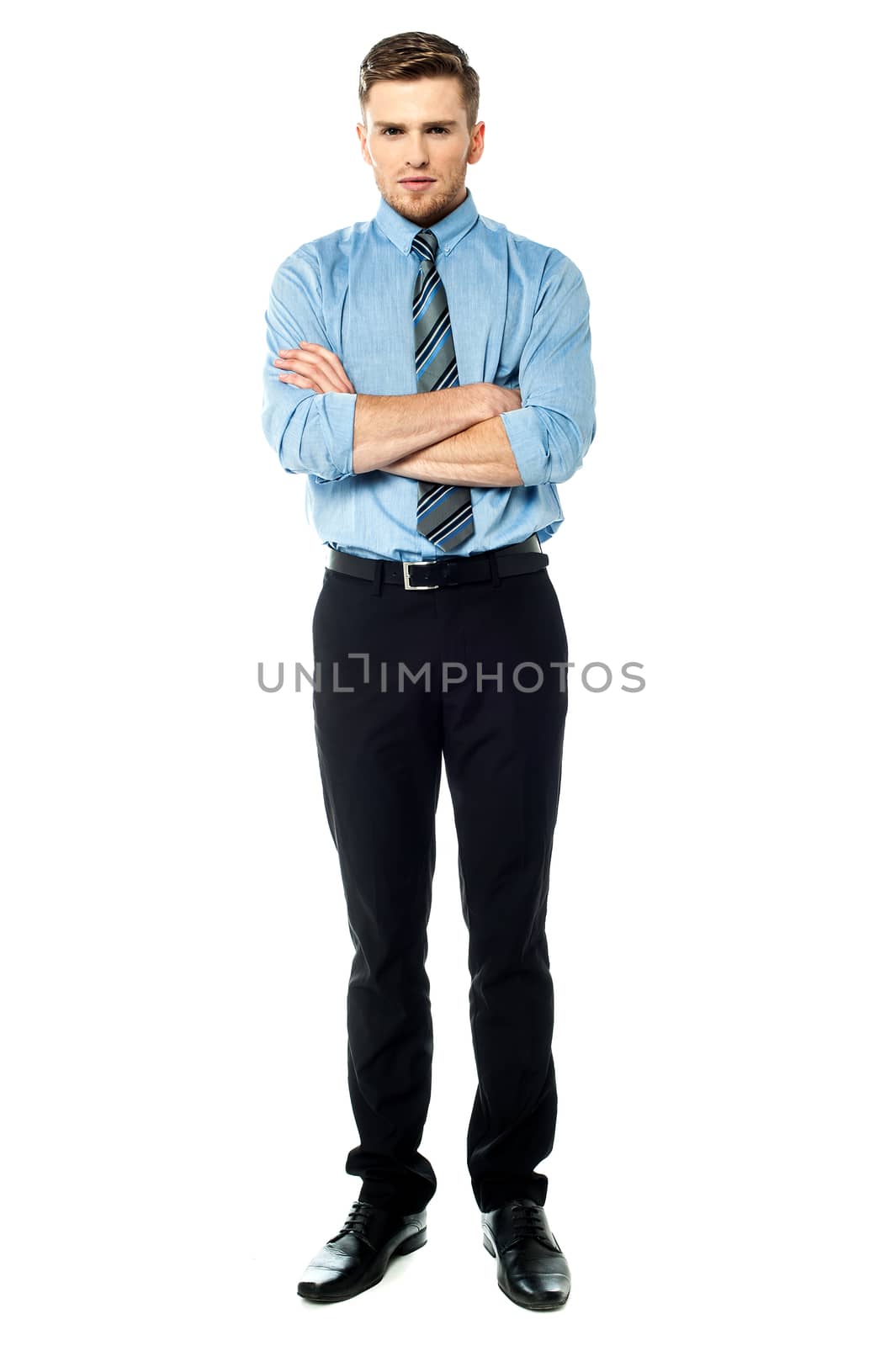 Handsome young businessman, arms crossed.