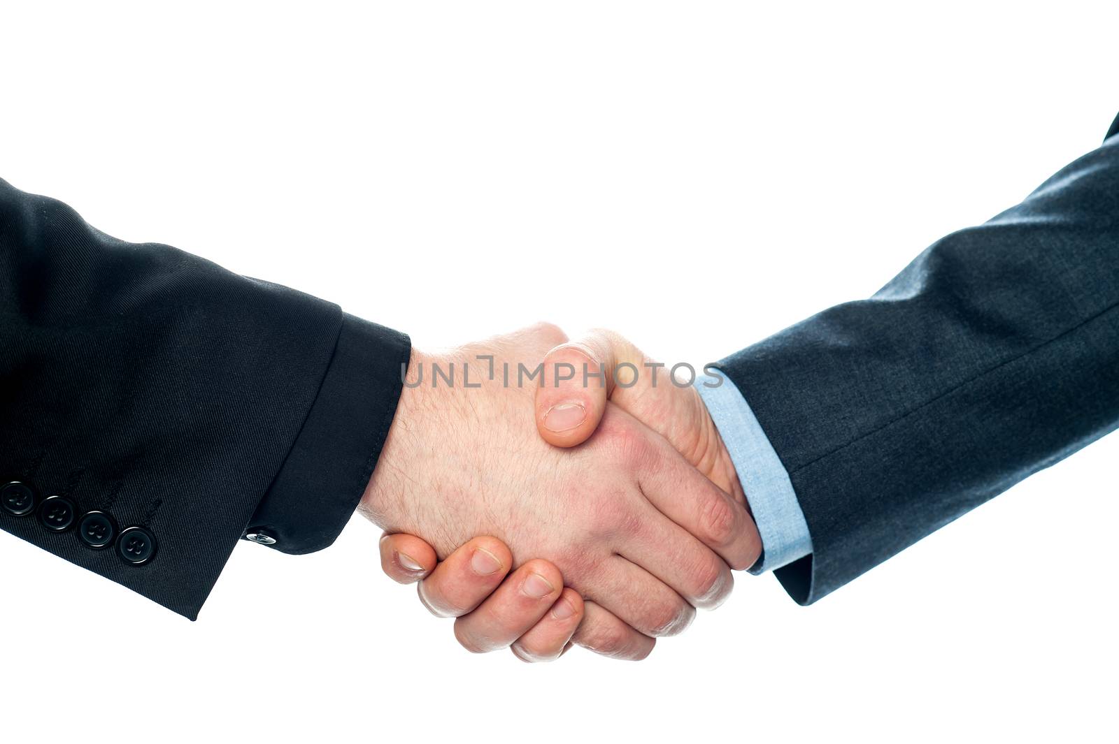 Businessmen shaking hands, closeup shot. by stockyimages