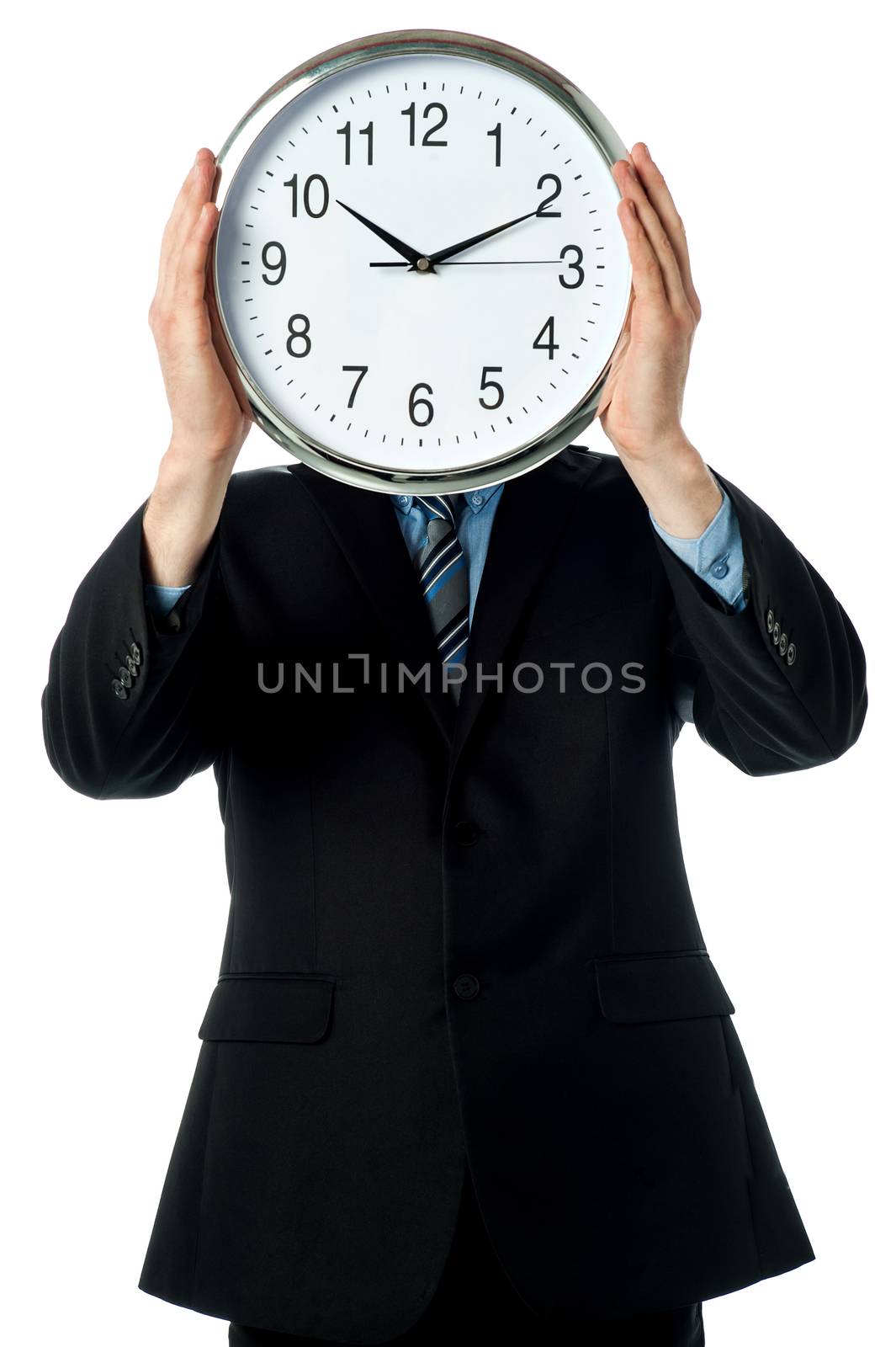 Man holding wall clock in front of his face