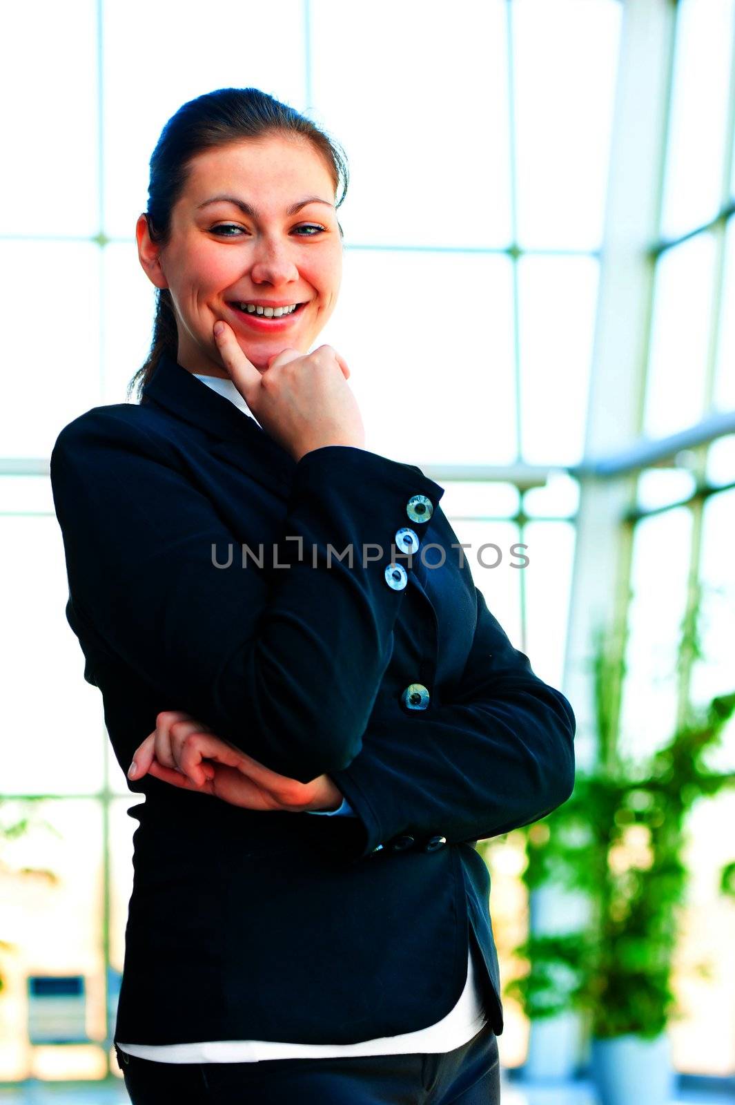 Portrait of smiling successful business people on the background of a blurred office interior by kosmsos111