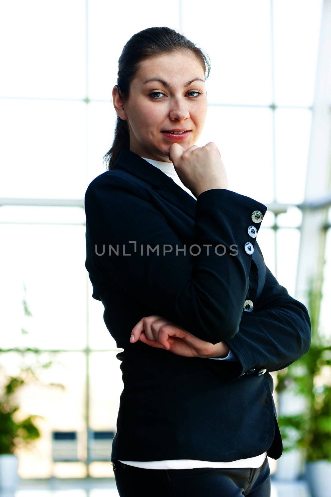 Portrait of a smiling girl on the background of the manager de-focus office interior by kosmsos111