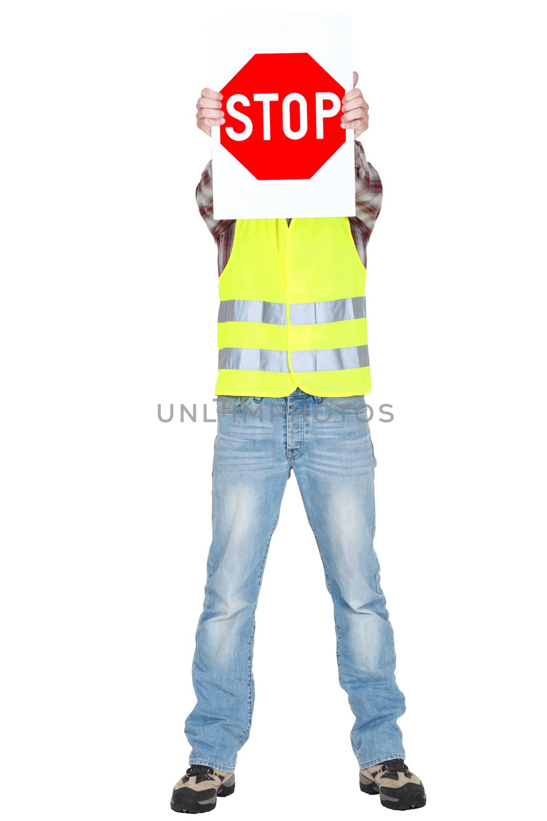 Builder covering face with stop sign
