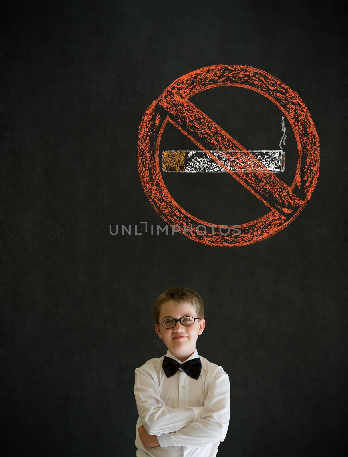 Thinking boy dressed up as business man with no smoking chalk sign on blackboard background