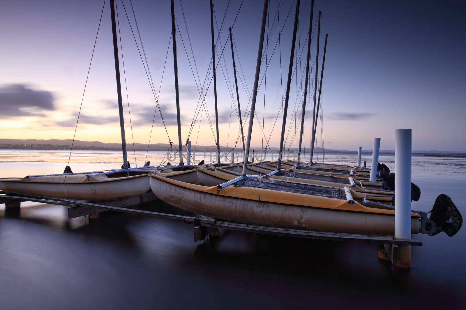 Catamarans moored on Tuggerah Lakes at Long Jetty, Australia after sundown. Long Exposure with lens filters