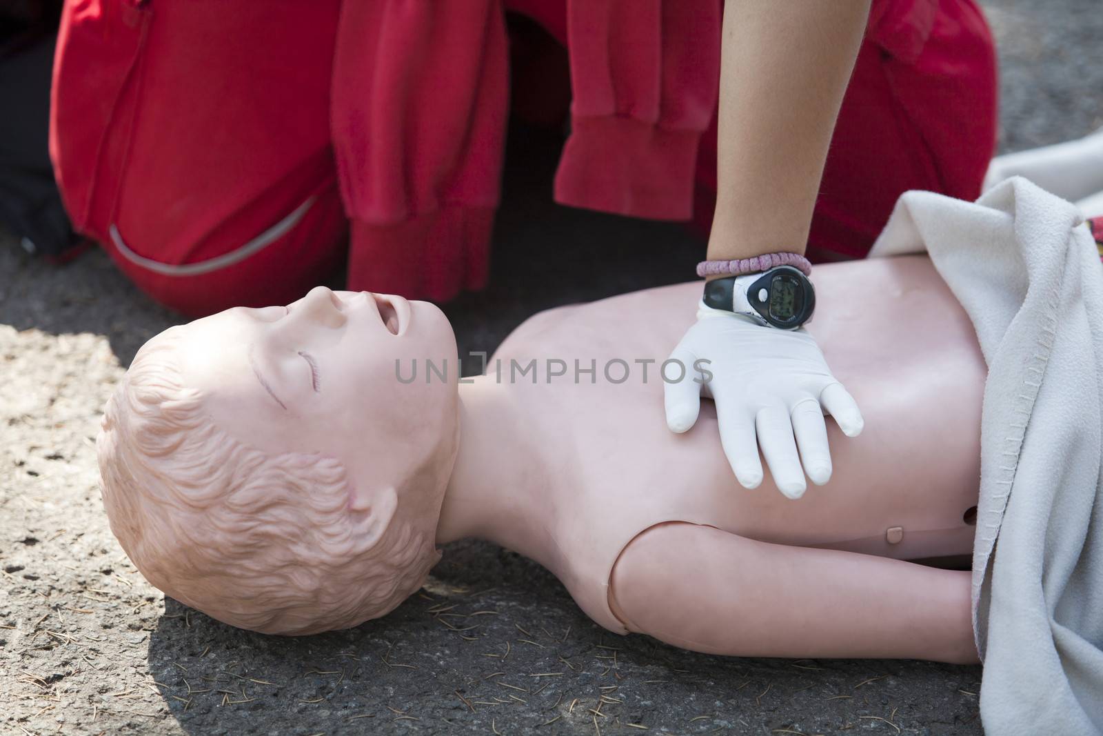 Paramedic demonstrates CPR on dummy