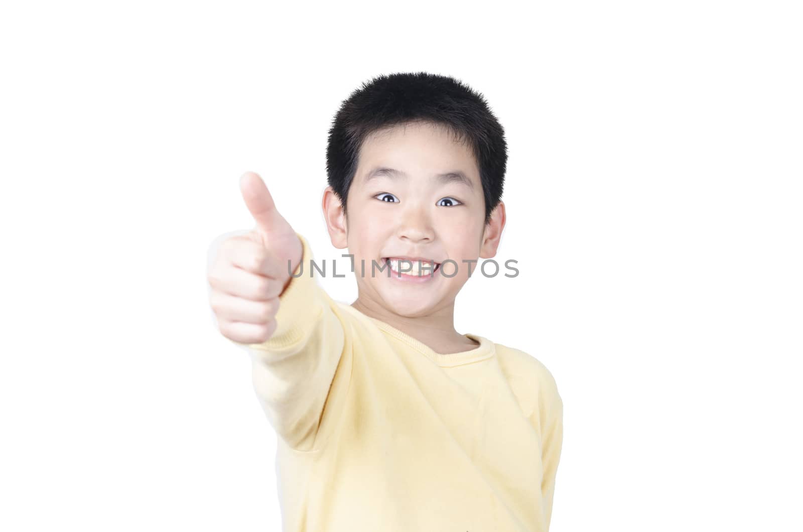 Joyful little boy holding his thumb up