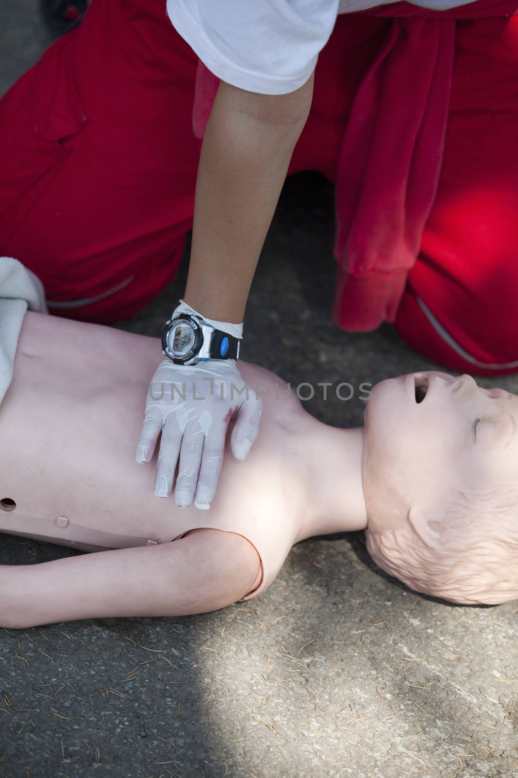 Paramedic demonstrates CPR on dummy