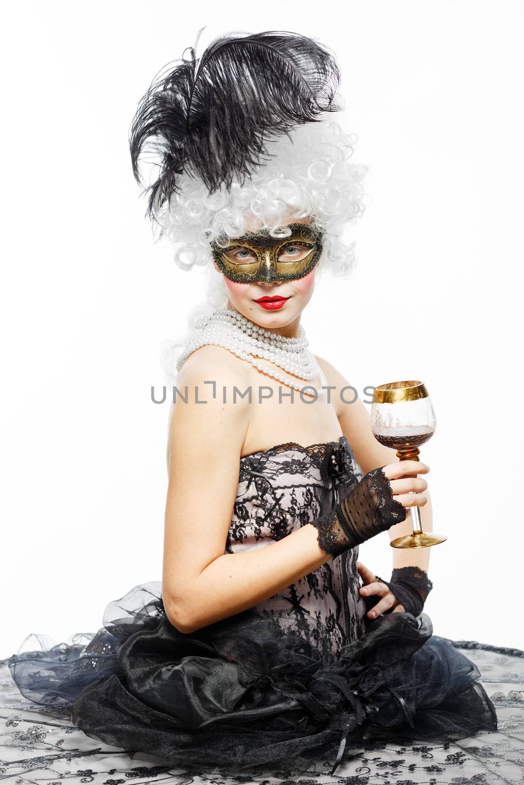 Masquerade in Venice. Princess in a black dress with a glass of wine.