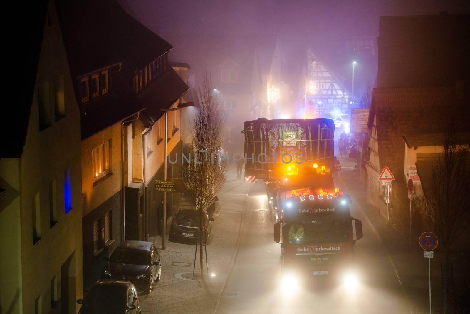 OSTFILDERN-SCHARNHAUSEN, GERMANY - DECEMBER 12, 2013: A heavy tunnel digging machinery is loaded on a flatbed trailer and carried to the construction site of Stuttgart 21 at night on December 12, 2013 in Ostfildern-Scharnhausen near Stuttgart, Germany. S21 is one of the most expensive and controversial railway projects ever with regular demonstrations against the plans to move the existing station underground going on.