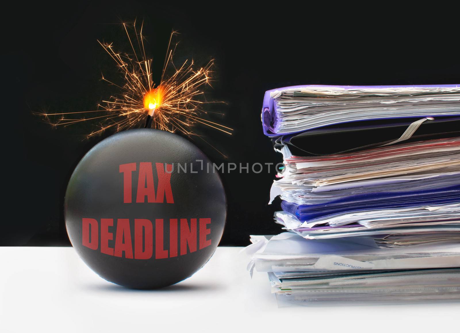 Exploding bomb labeled tax deadline next to a pile of paperwork