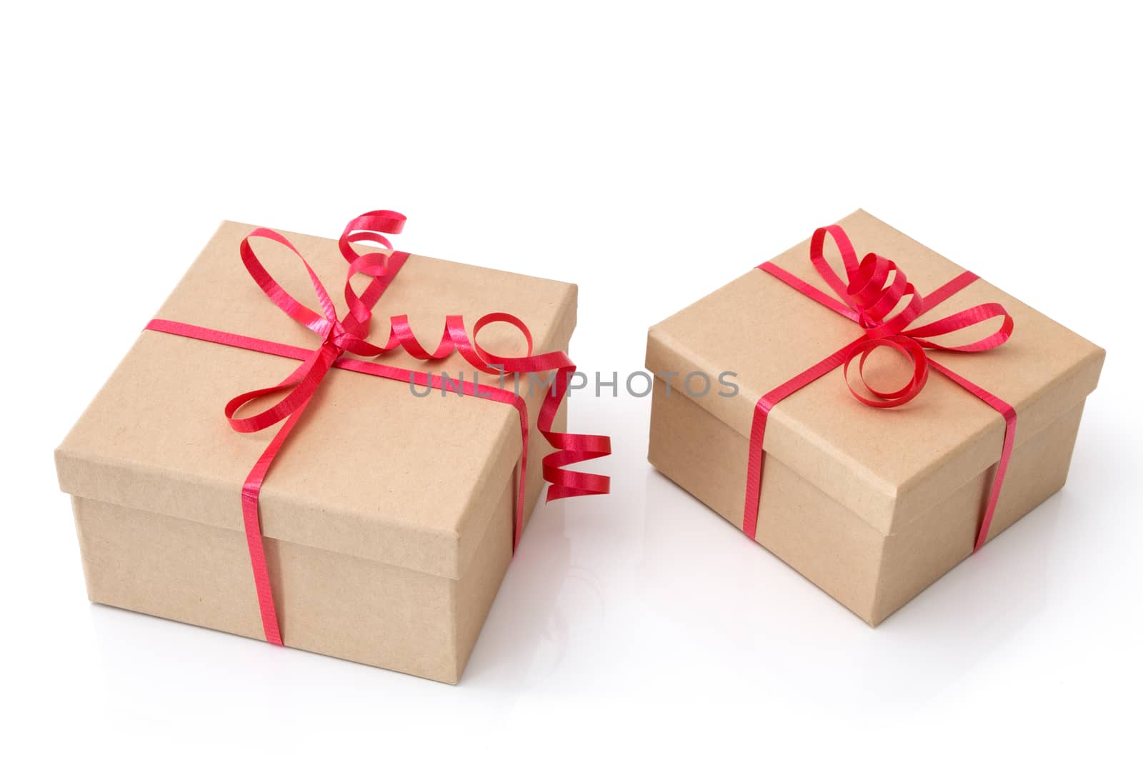 Two simple gift boxes with red ribbons, isolated on white background.