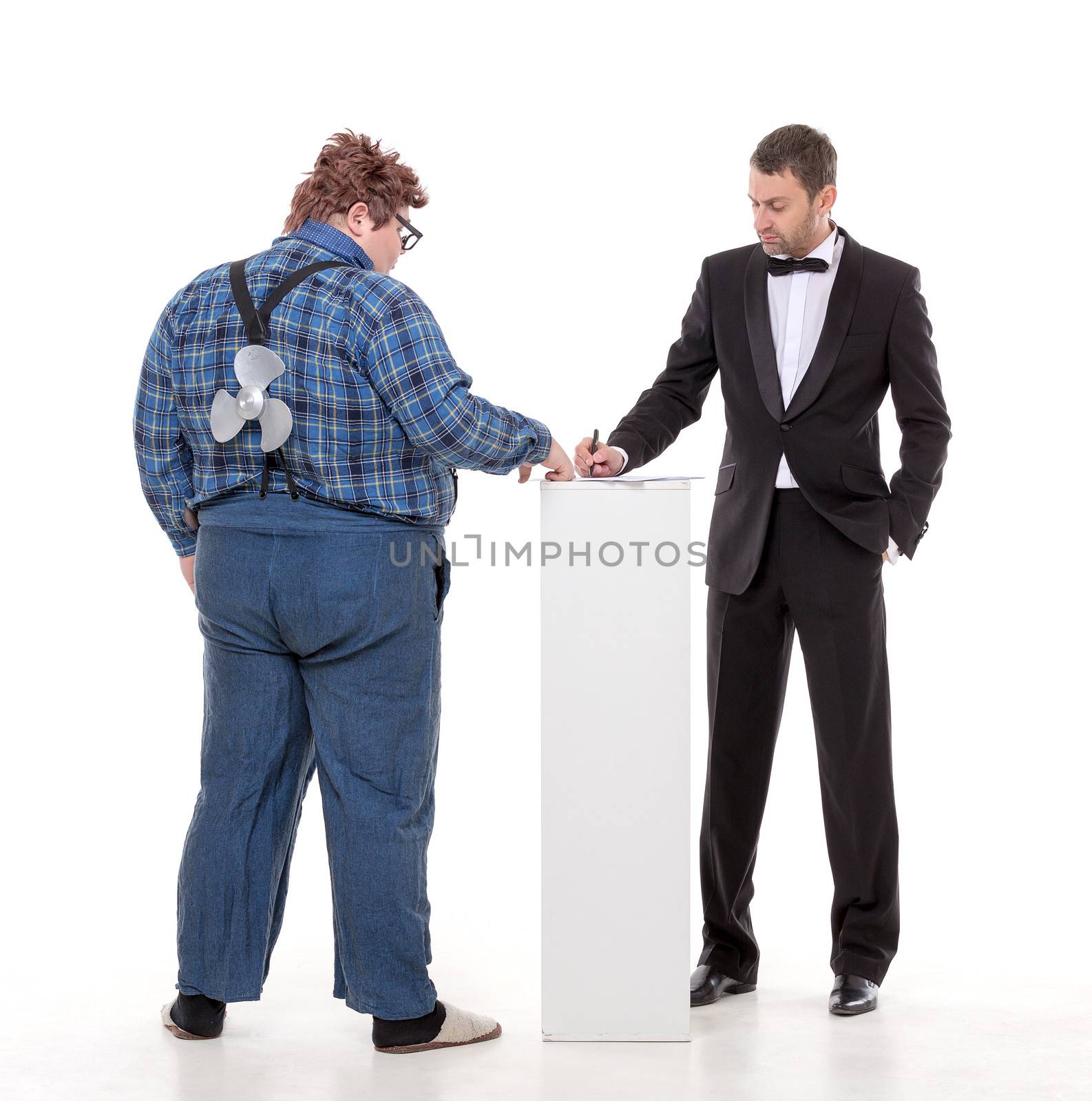 Elegant man in a tuxedo and bow tie standing arguing with an overweight country yokel
