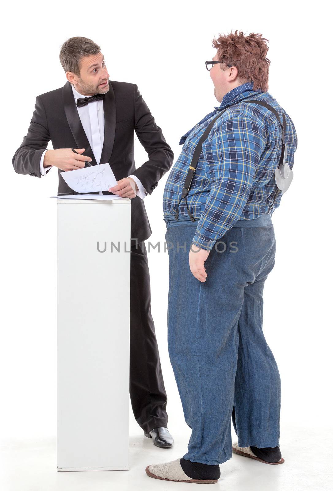 Elegant man in a tuxedo and bow tie standing arguing with an overweight country yokel
