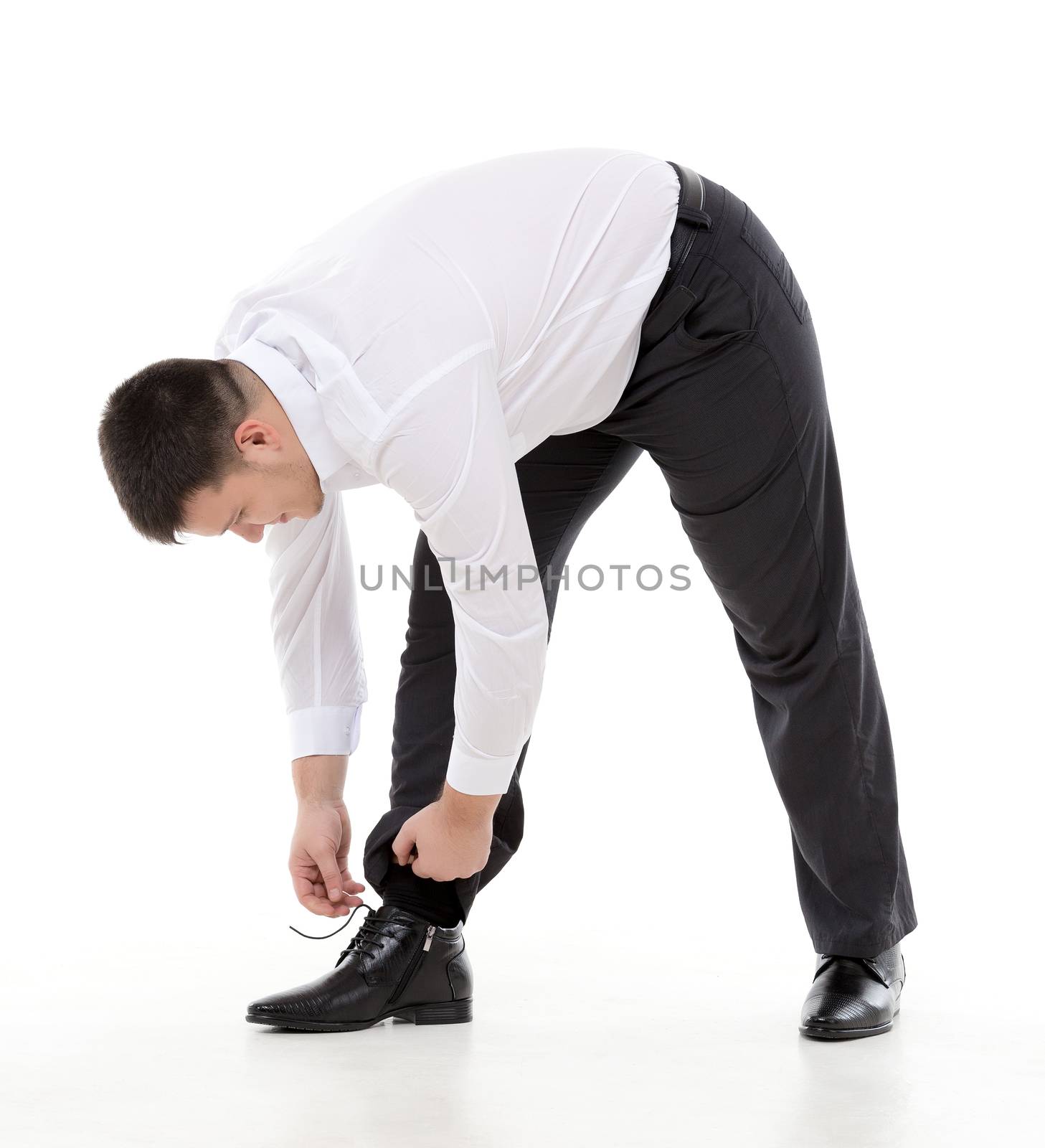 Man bending down to do up his shoelaces by Discovod