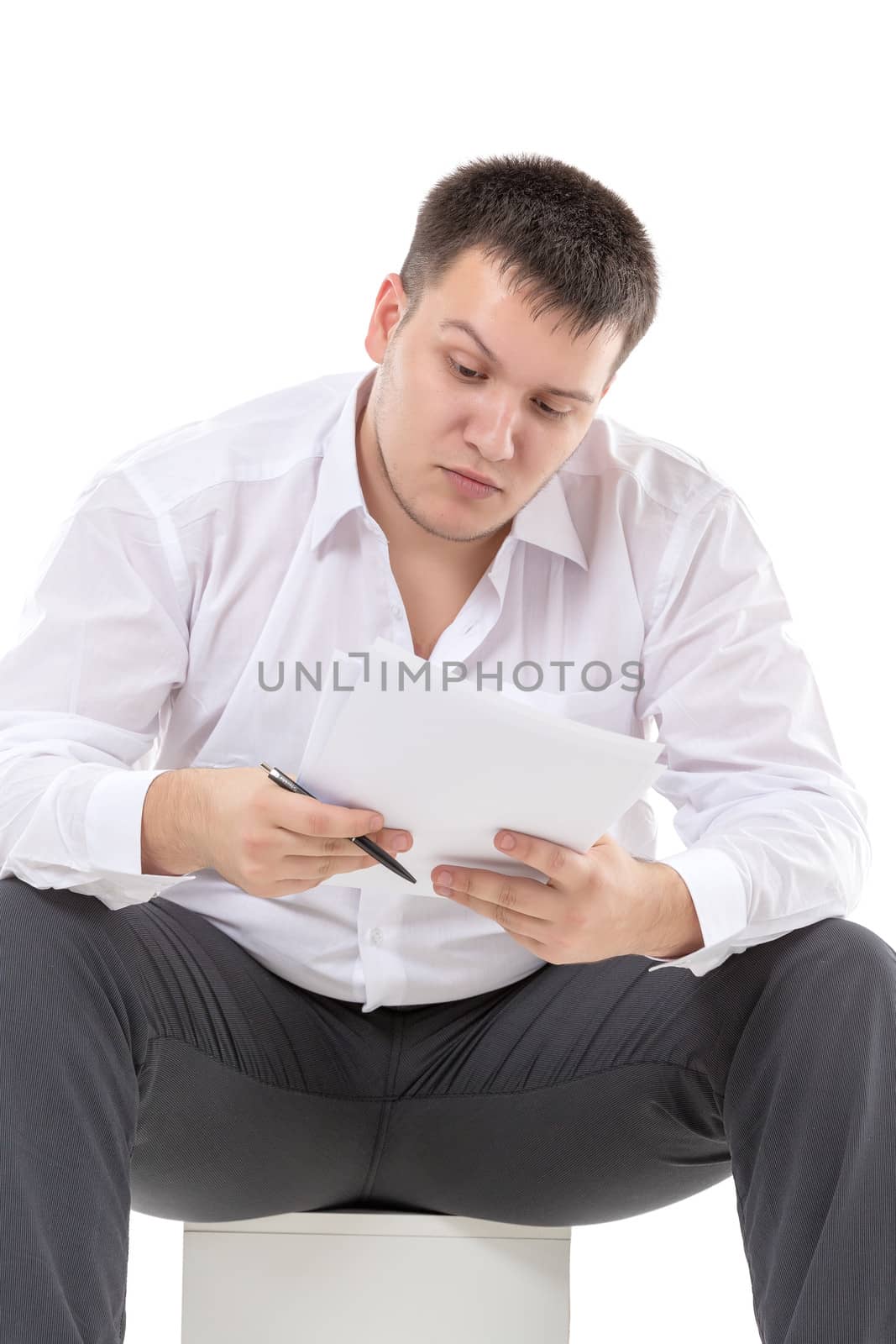 Businessman reading a report with scepticism by Discovod