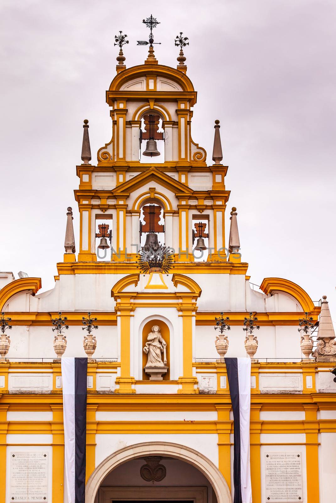 Basilica de la Macarena Bell Tower with Bronze Bells and Weather Vanes Seville, Andalusia Spain.  Built in the 1700s. Houses the statue of the Macarena, the Virgin Mary with tears.