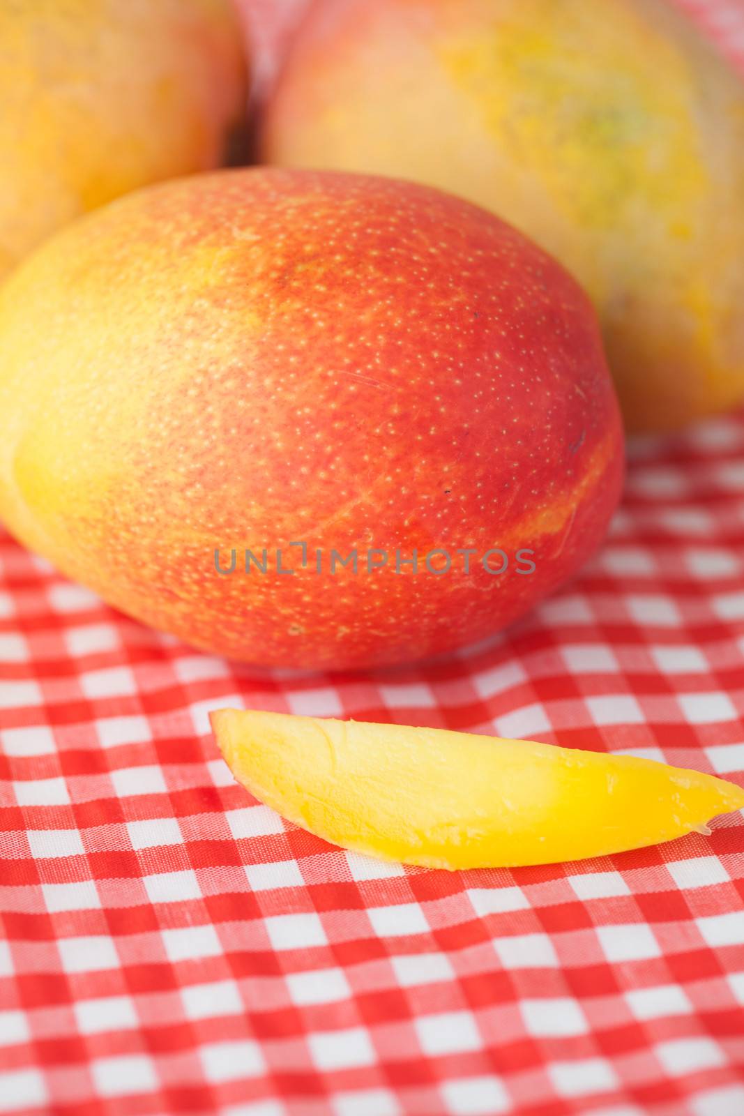 mango fruit on checkered fabric