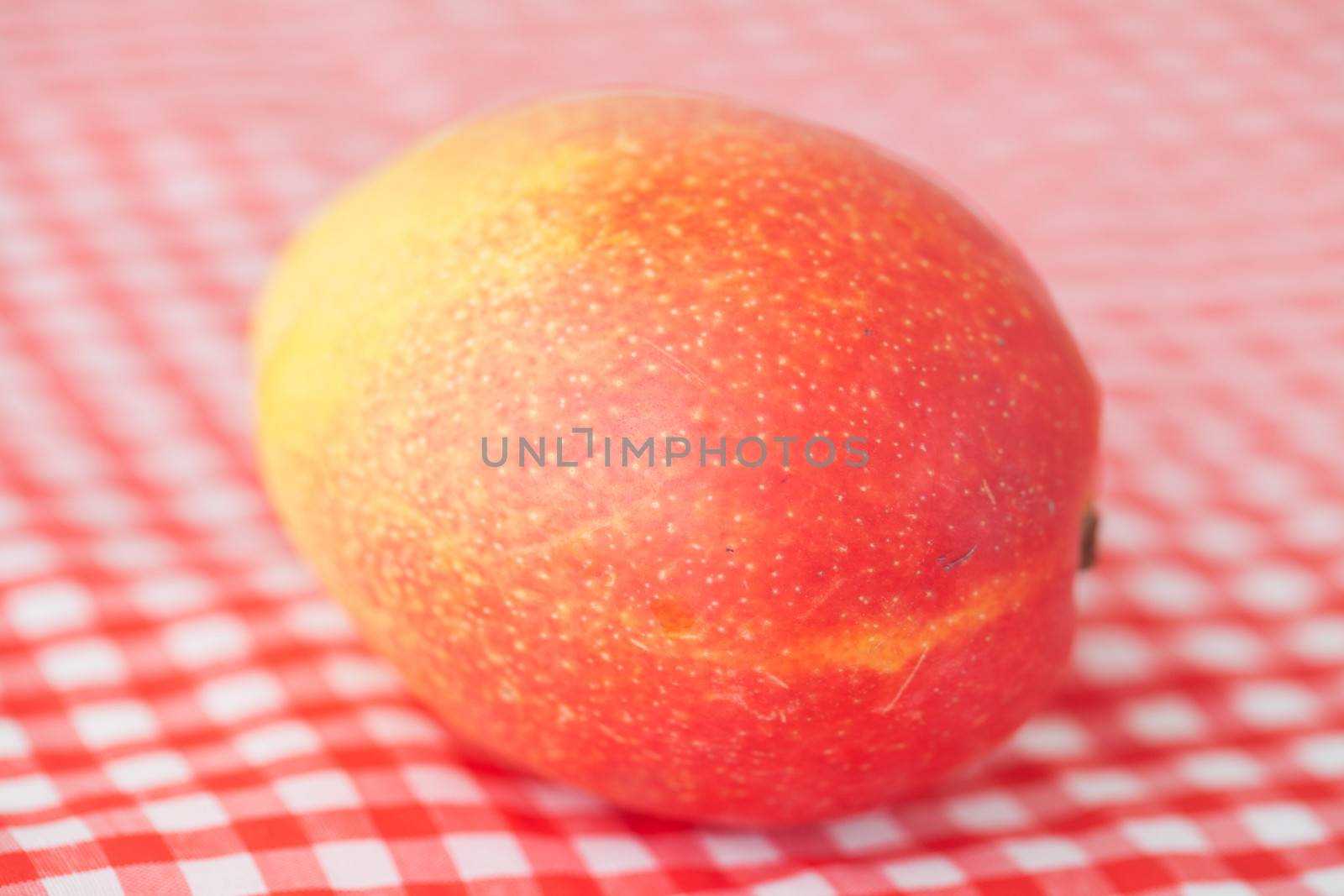 mango fruit on checkered fabric