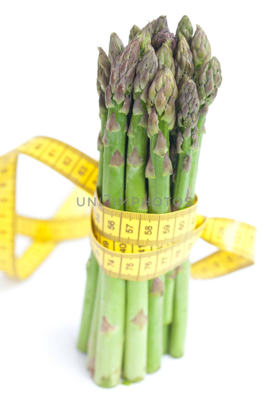 asparagus tied with measuring tape isolated on white