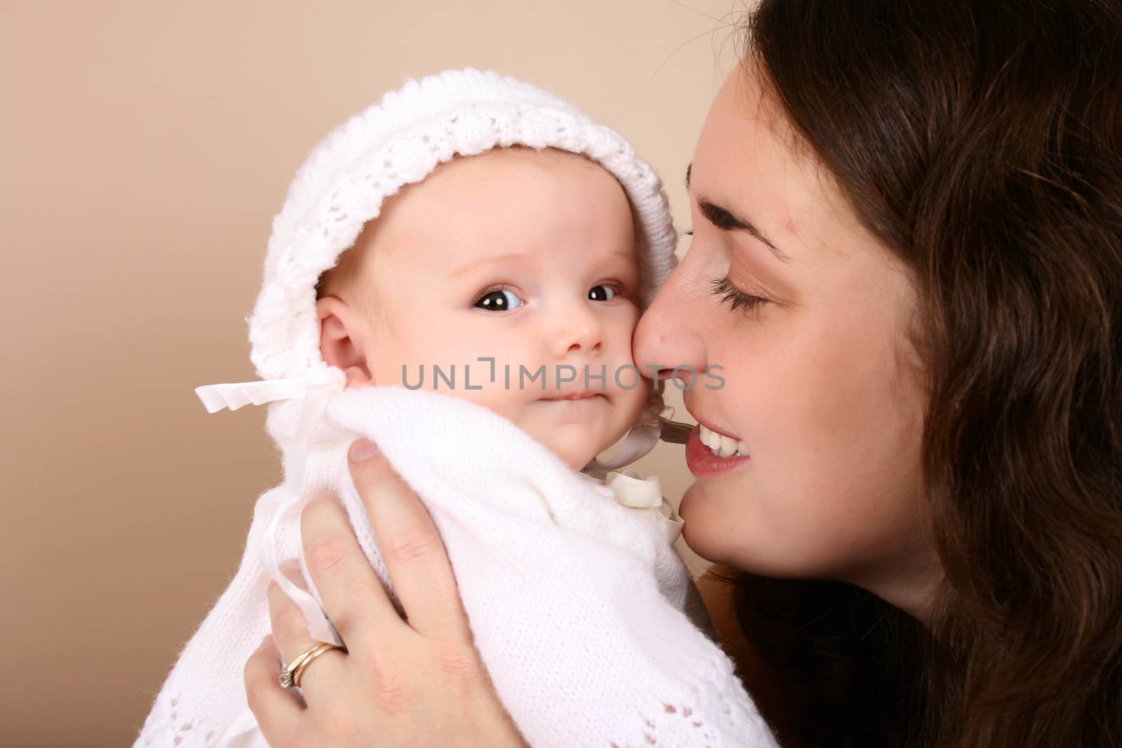 Brunette mother and baby girl dressed in white